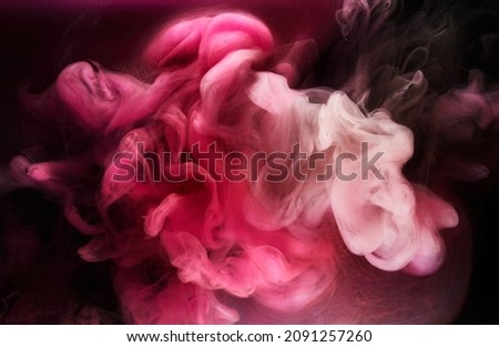Pink smoke on black ink background, colorful fog, abstract swirling touch ocean sea, acrylic paint pigment underwater Royalty-Free Stock Photo #2091257260