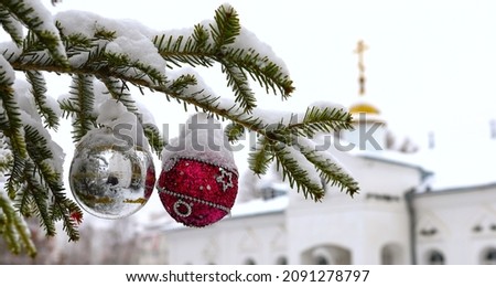 Christmas tree branch with decorations on the background of the Orthodox cross with a crucifix. The Orthodox Church. Winter is Christmas. The concept of Orthodoxy. Royalty-Free Stock Photo #2091278797