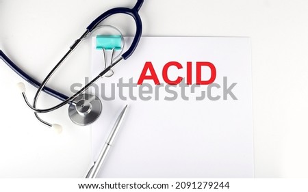 ACID text written on the paper with a stethoscope. Medical concept.