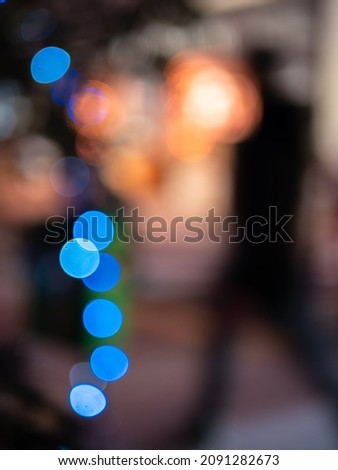 Deliberateljy out of focus Christmas lights - a sihouette of a blurred man walking through the illuminated Christmas atmosphere.