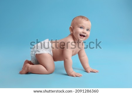 Cute baby in dry soft diaper crawling on light blue background Royalty-Free Stock Photo #2091286360