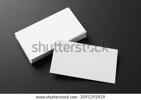 Blank business cards on black background, above view. Mockup for design Royalty-Free Stock Photo #2091292429