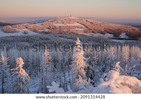 Pastel colored winter wonderland in the Harz National Park, Harz mountains, Germany. Snow-covered forest of Mount Wurmberg near the town of Braunlage, Lower Saxony.  Royalty-Free Stock Photo #2091314428