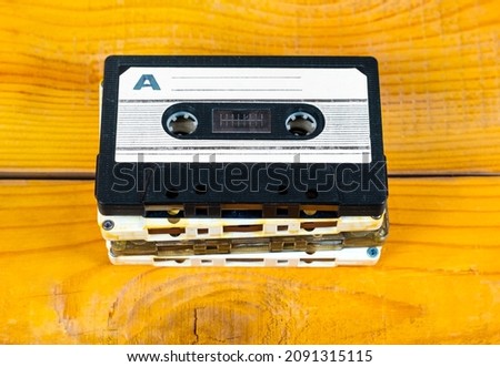 Old Audio Cassettes Set on a Wooden Planks Background closeup