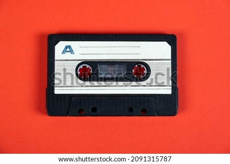 Old Audio Cassettes on the Red Paper Background closeup