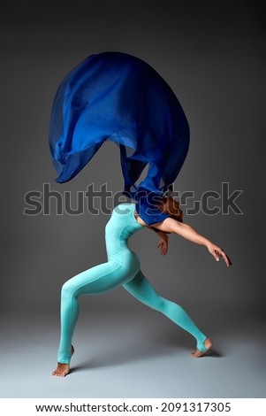 Ballerina Dancing with Silk Fabric, Modern Ballet Dancer in Fluttering Waving Cloth, Gray Background