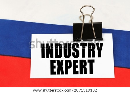 National concept. On the flag of Russia there is a business card with the inscription - Industry expert