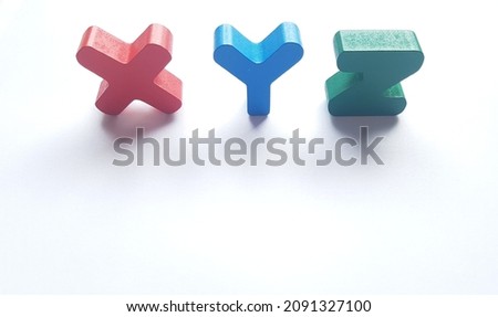 Back to school! XYZ red, blue and green blocks on a white background with spavlce left open for copy.