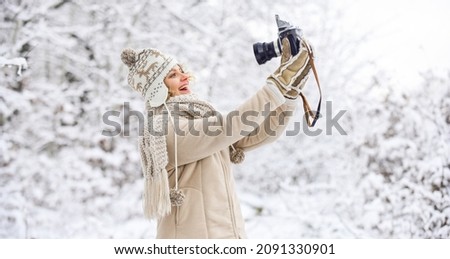 Cheerful winter girl. winter girl with vintage camera. happy woman make selfie on camera. winter selfie. having fun outdoor snowy forest. cold weather brings good mood. ready for weather forecast