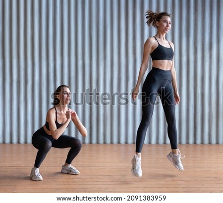 Fit woman exercising doing jump squat Fitness female athlete Royalty-Free Stock Photo #2091383959