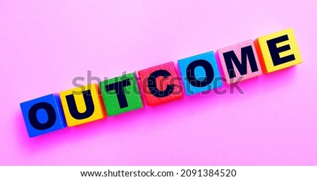 On a light pink background, multi-colored wooden cubes with the text OUTCOME