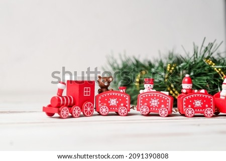 The concept of the coming new year, christmas. New Year's red train with a green branch on a white background.