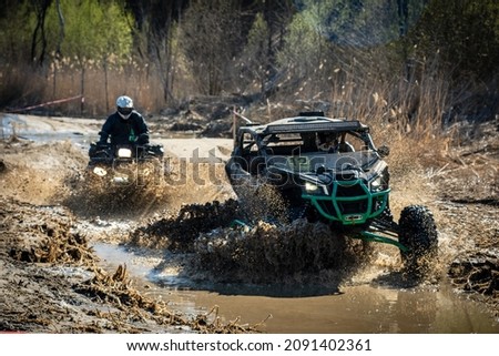 ATV and UTV riding in hard track with mud splash. Amateur competitions. 4x4. Royalty-Free Stock Photo #2091402361