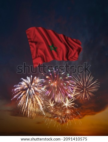 Holiday fireworks in evening sky and flag of Morocco for National Independence day Royalty-Free Stock Photo #2091410575
