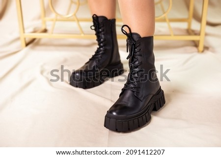 Black women's boots made of genuine leather. New collection of winter shoes for stylish girls. Fashionable women's stylish leather boots. Royalty-Free Stock Photo #2091412207