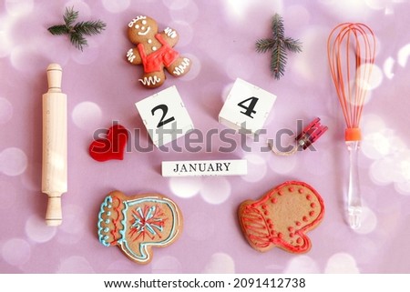Calendar for January 24: name of the month in English, cubes with the number 24, gingerbread men, mittens, fir branches, toy sleds, kitchen utensils, red heart on a pastel background