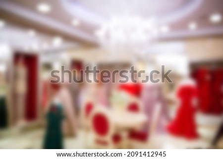 blurred background shop of wedding and evening dresses