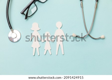 Family health care therapy medical concept. Flat lay family cutout symbol model stethoscope glasses on blue background. Health check up life insurance concept. Clinic hospital for parents child banner