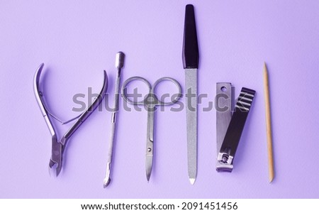 Accessories for manicure and pedicure lie on a gray background, close-up.  Photo top view, banner.  Hand and body care concept.