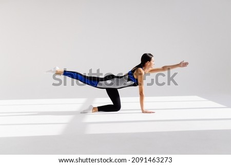 one caucasian woman exercising fitness Yoga excercises in silhouette isolated on white background