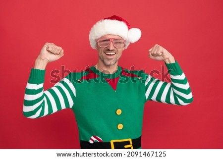 happy successful man in elf costume and party glasses. xmas guy in santa claus hat