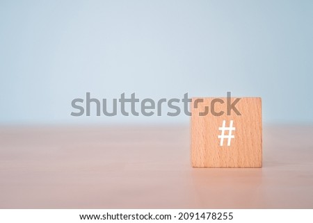 A wooden block with a hash tag sign.