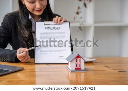 Portrait of a real estate agent or buyers are offering discounts on home insurance Sign a contract to buy and sell a house. Sign a contract. Signing concept.