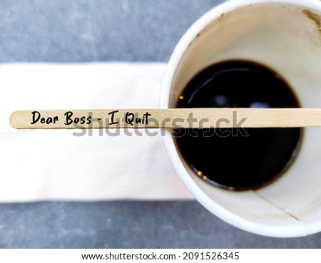 Coffee stirer with text handwritten DEAR BOSS I QUIT on coffee cup, decision making to quit job or resign from corporate full time work, employee voluntarily leaving job to find work life balance Royalty-Free Stock Photo #2091526345
