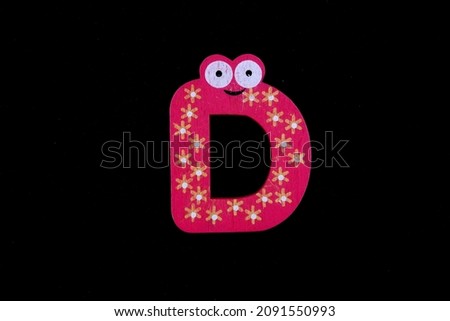 Alphabet letters D on colorful wooden pieces for kids. 
