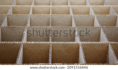 Abstract background. Square cardboard partitions close-up. Partitions for transporting fragile glass items. Royalty-Free Stock Photo #2091556846