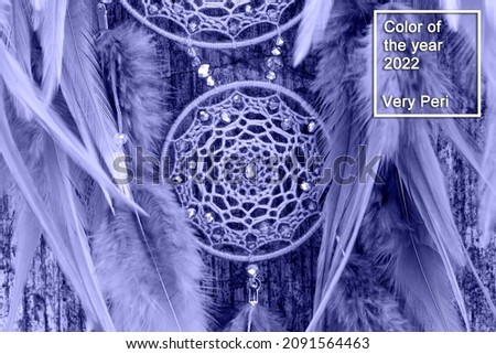 Dream catcher with feathers threads and beads rope hanging. Dreamcatcher handmade in very pei trendy color. background. Color of the year 2022.
