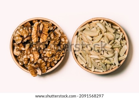 Top view close up or macro Walnuts and almond flakes They’re good sources of fiber, healthy fats, and plant protein. Great on their own, paired with fruit, or added in salads, desserts, and grains.
