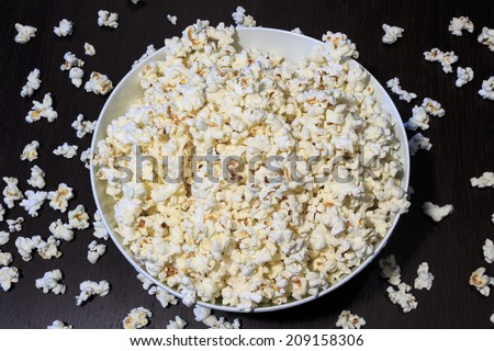 Bowl of popcorn on a dark brown wooden table