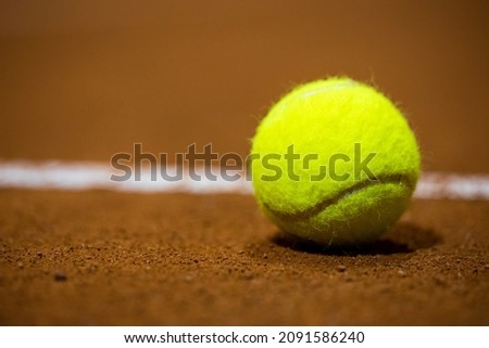Tennis ball on the tennis court. Gravel. Tennis game. Sport, recreation concept