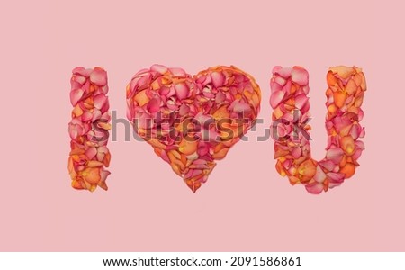I love you sign inspired concept. Beautiful short text made of roses petals. Flat lay arrangement against gentle pink background