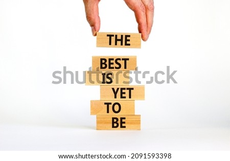 The best is yet to be symbol. Wooden blocks with concept words The best is yet to be. Beautiful white background, copy space. Businessman hand. Business, the best is yet to be concept.