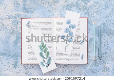 Book with bookmarks on color background