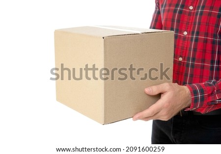 Man in a red checkered shirt holding a cardboard box isolated on white. Holidays season delivery concept.