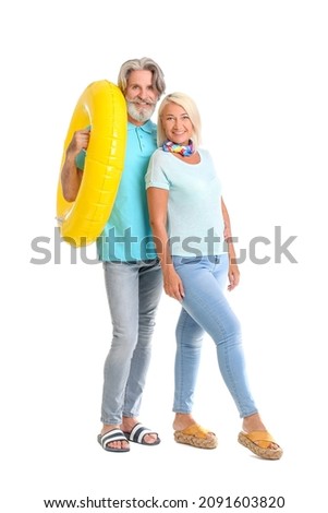 Mature couple with inflatable ring on white background