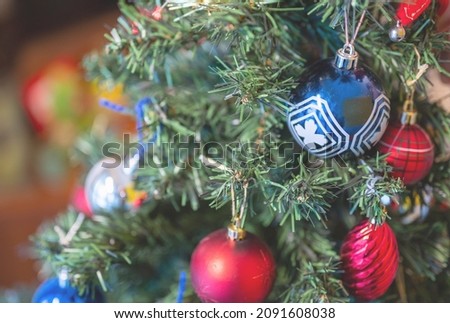 Christmas is Coming: Conceptual close-up image of the decorative balls on the branches of the Christmas tree.
