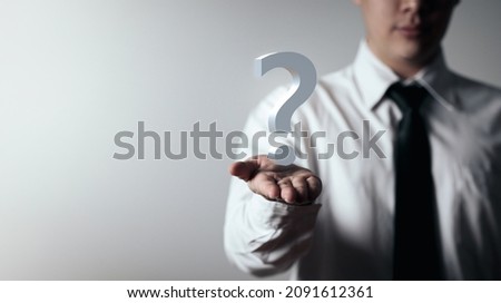 Man holding question mark icon. concept of doubt Asking questions and finding solutions to problems. with copy space