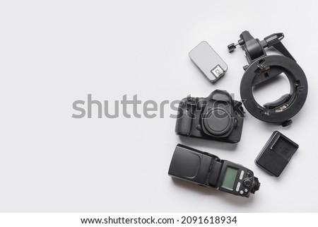 Modern photographer's equipment on light background