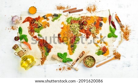 World map made of different spices on a white wooden background. Top view.