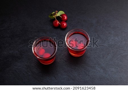 Ginjinha or Ginja - Tradition Portuguese liqueur made by infusing ginja berries (sour cherry, Prunus cerasus austera, Morello cherry) in alcohol (aguardente) and adding sugar. Royalty-Free Stock Photo #2091623458