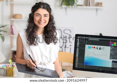 Graphic designer working in office Royalty-Free Stock Photo #2091624997