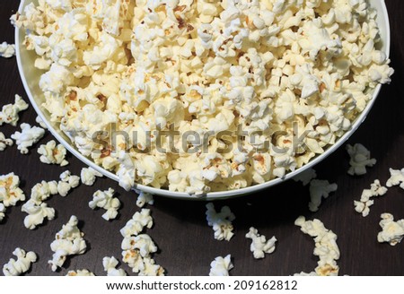 Bowl of popcorn on a dark brown wooden table