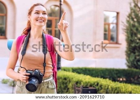 Female tourist with camera on city street