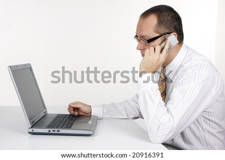 businessman talking on the phone, working on  laptop