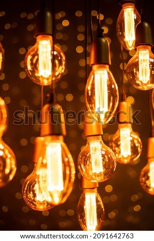 Burning vintage lamps on a black background. Close-up light bulbs. Lamp.