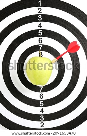 Concept achieving goal.Achieving goals in business and life.Dartboard with darts stuck right bullseye